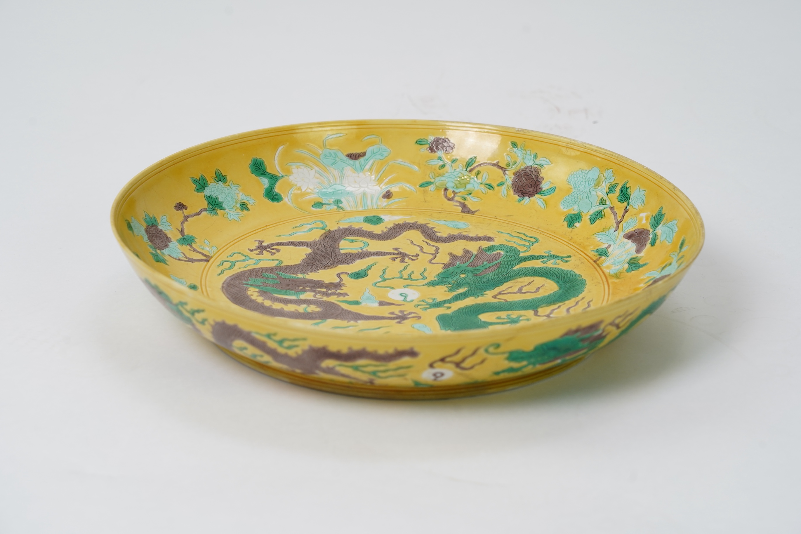 A Chinese yellow, green and aubergine glazed and incised ‘dragon’ dish, chuxiugong zhi hall mark, possibly Guangxu period